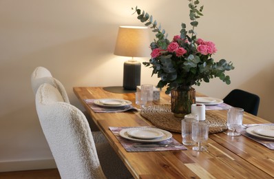 Photo of Beautiful table setting with bouquet and candles in room. Space for text