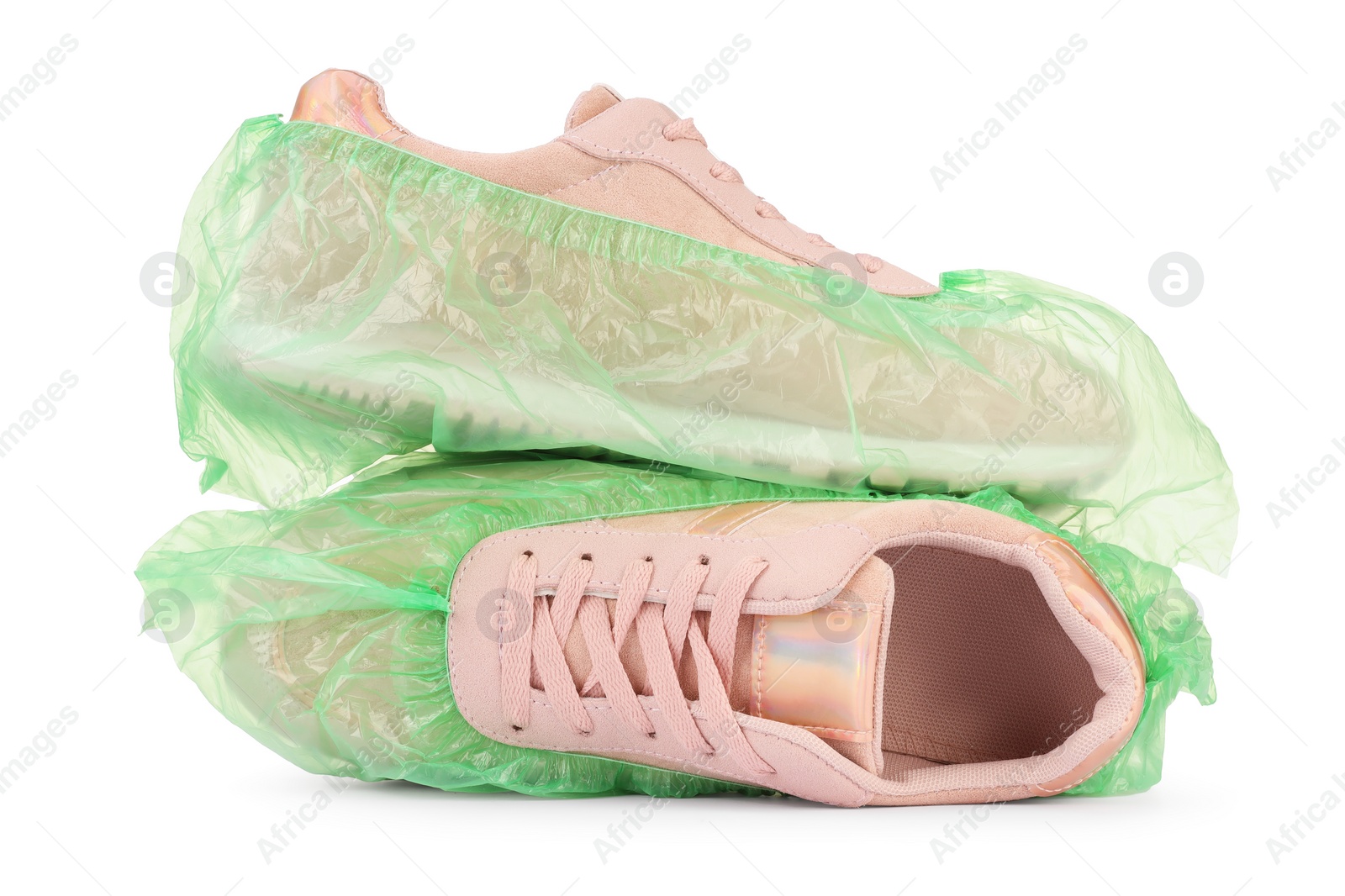 Photo of Sneakers in green shoe covers isolated on white