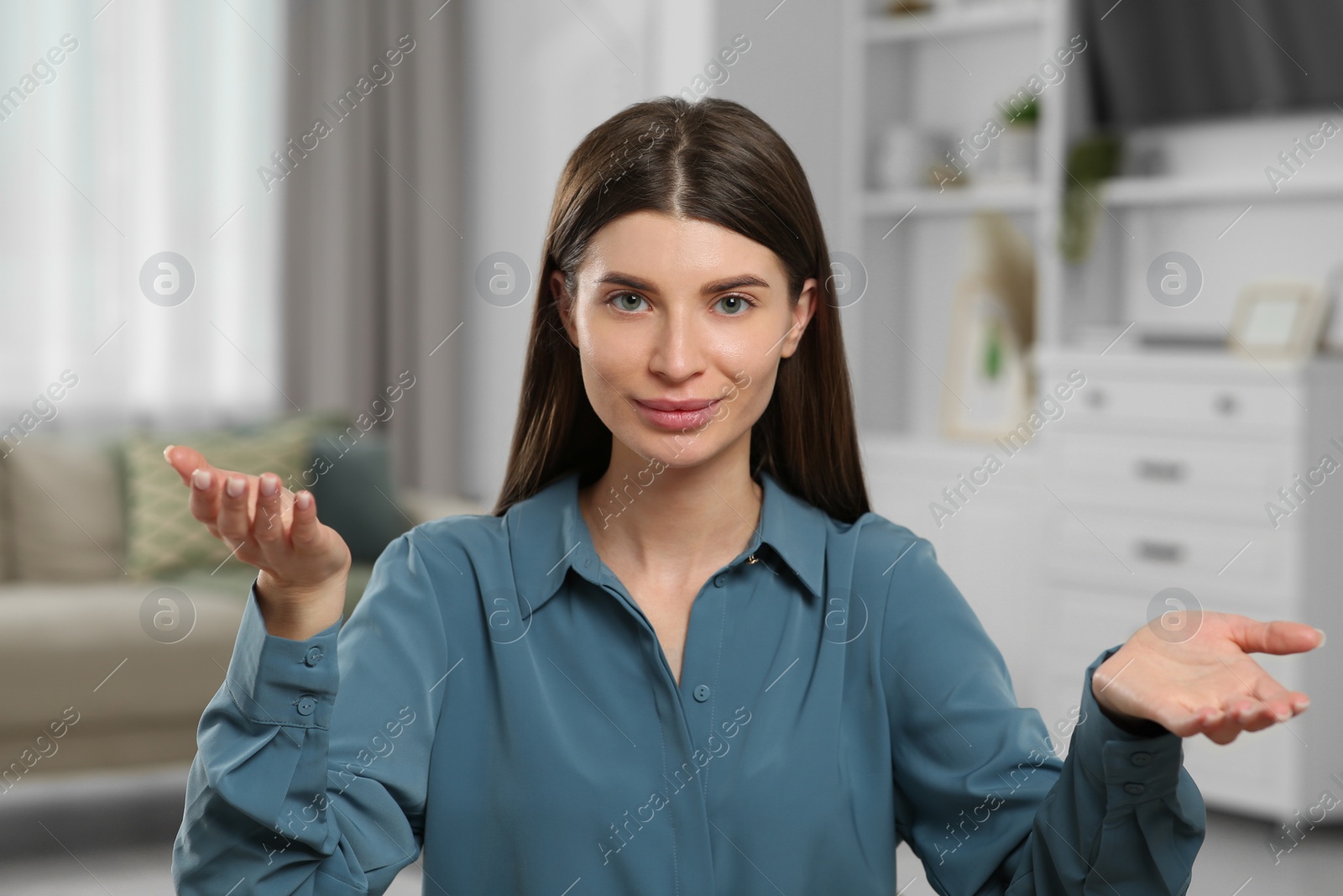 Photo of Young woman having online video call at home, view from web camera