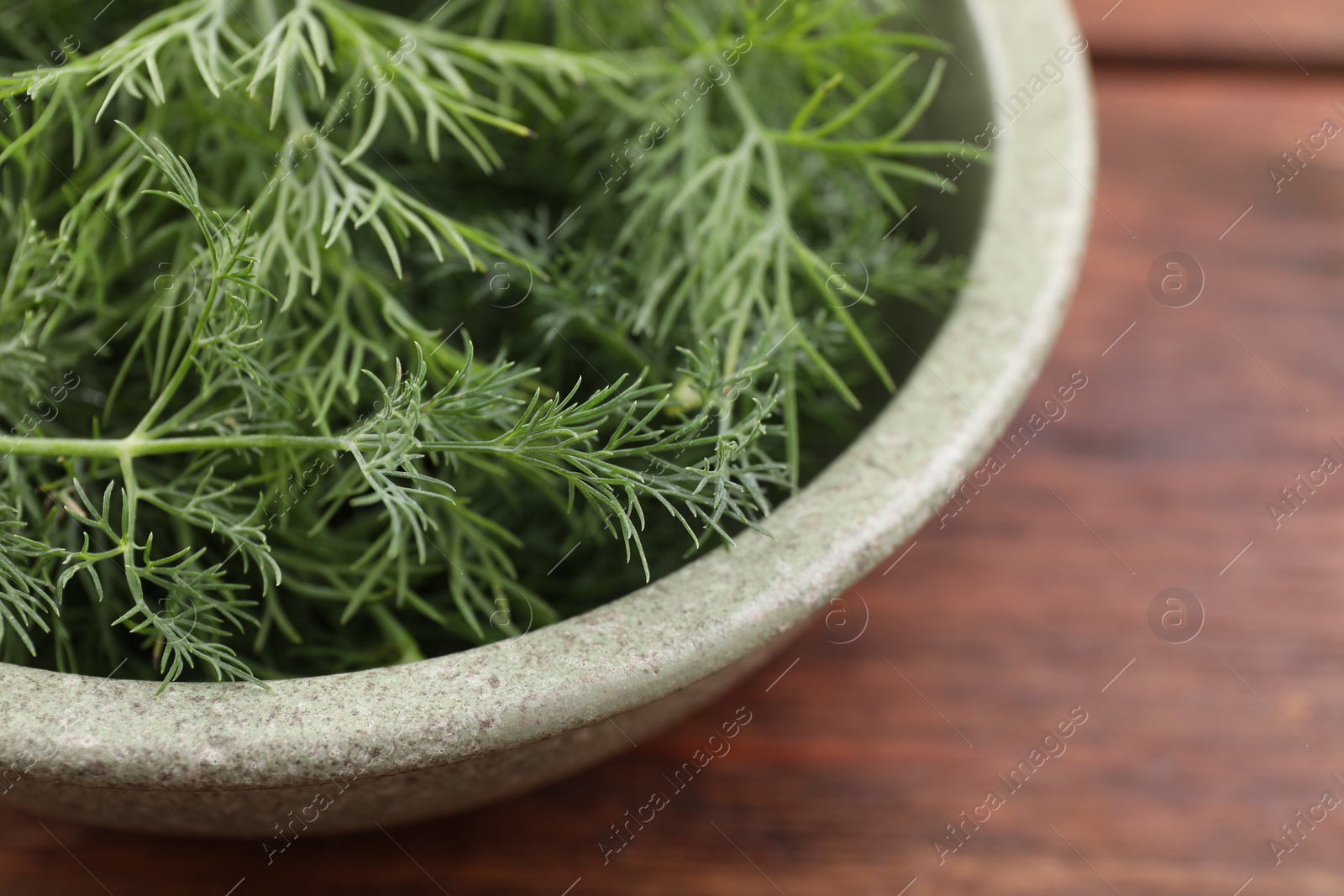 Photo of Bowl of fresh dill on table, closeup. Space for text