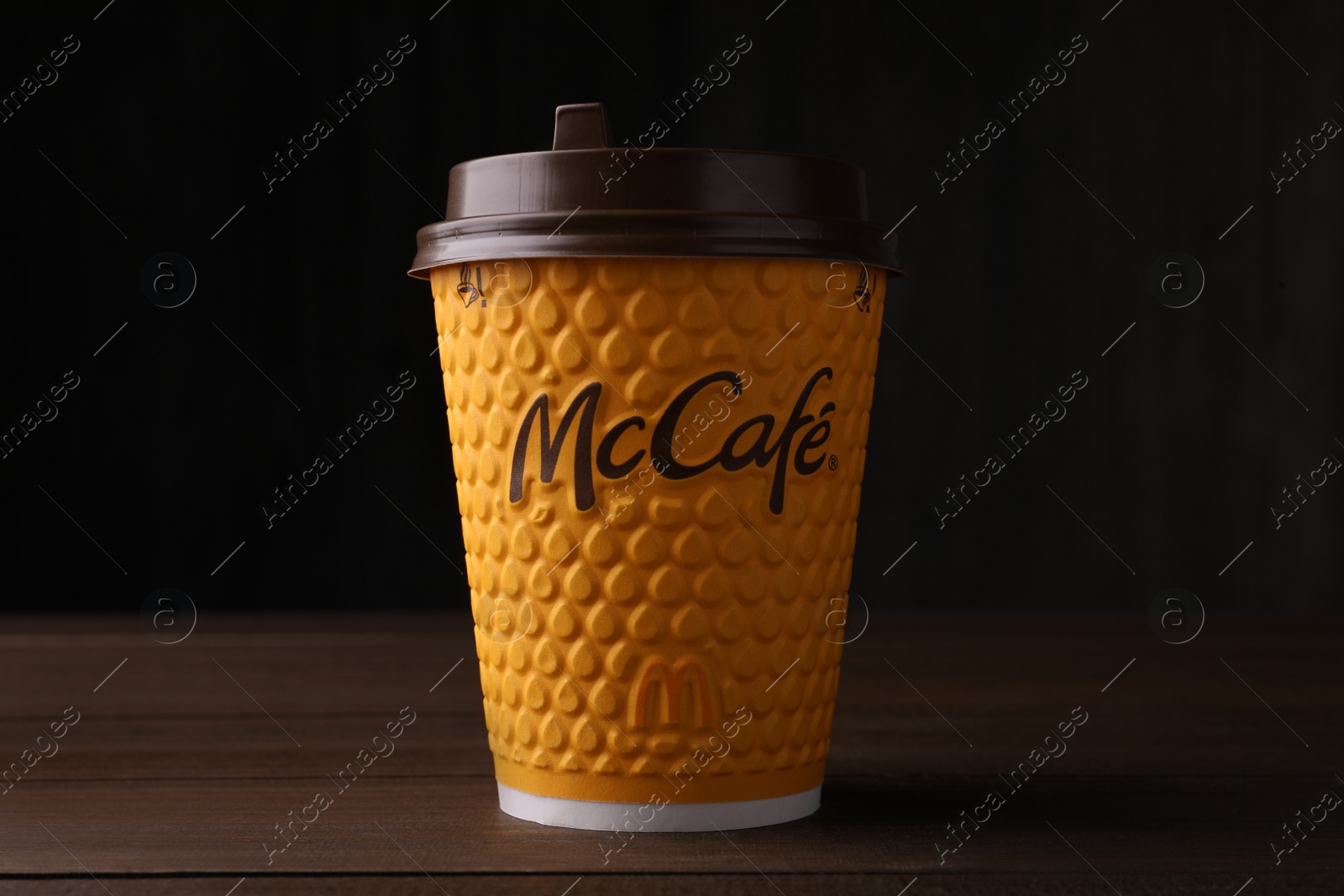 Photo of MYKOLAIV, UKRAINE - AUGUST 12, 2021: Hot McDonald's drink on wooden table