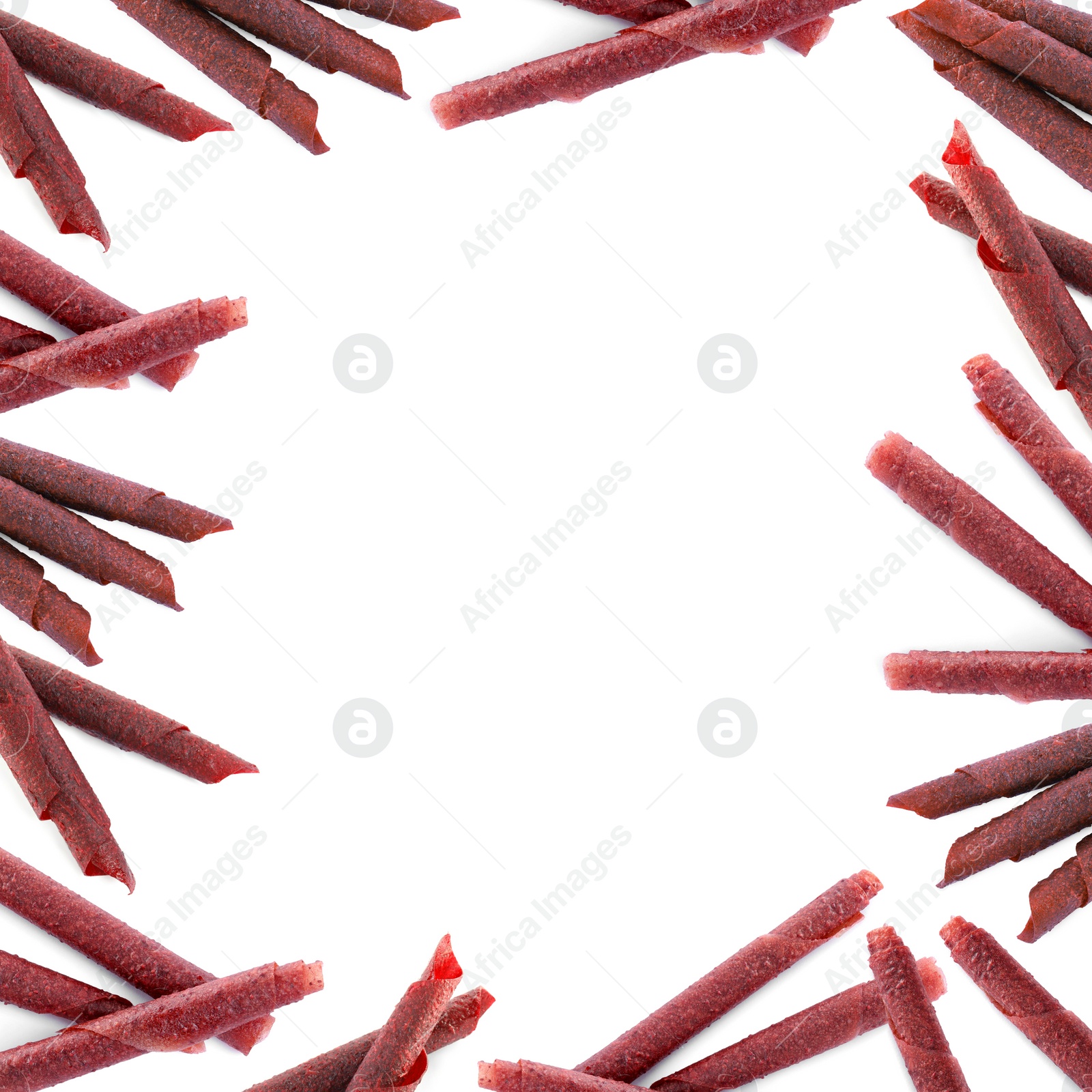 Image of Frame made of delicious fruit leather rolls on white background