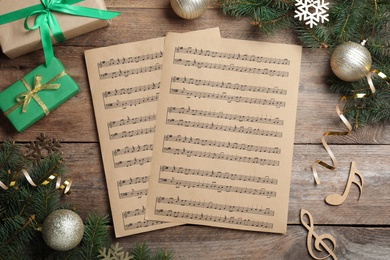 Flat lay composition with Christmas music sheets on wooden background