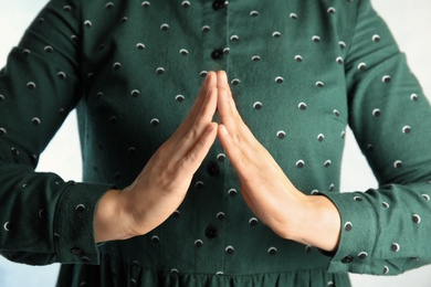 Woman showing word house, closeup. Sign language