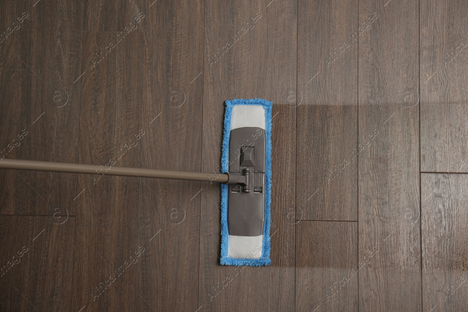 Photo of Cleaning of wooden floor with mop, top view