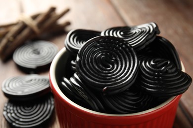 Photo of Tasty black liquorice candies on table, closeup