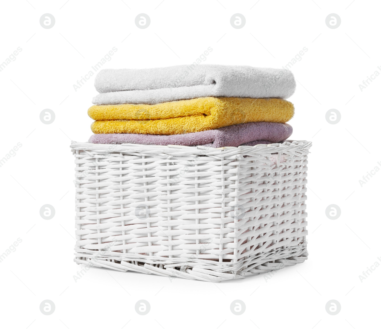 Photo of Wicker laundry basket with folded towels isolated on white