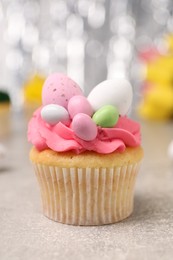 Photo of Tasty decorated Easter cupcake on grey table, closeup