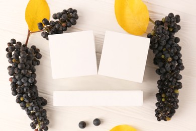 Photo of Thanksgiving day, holiday celebrated every fourth Thursday in November. Block calendar, yellow leaves and berries on white wooden table, flat lay