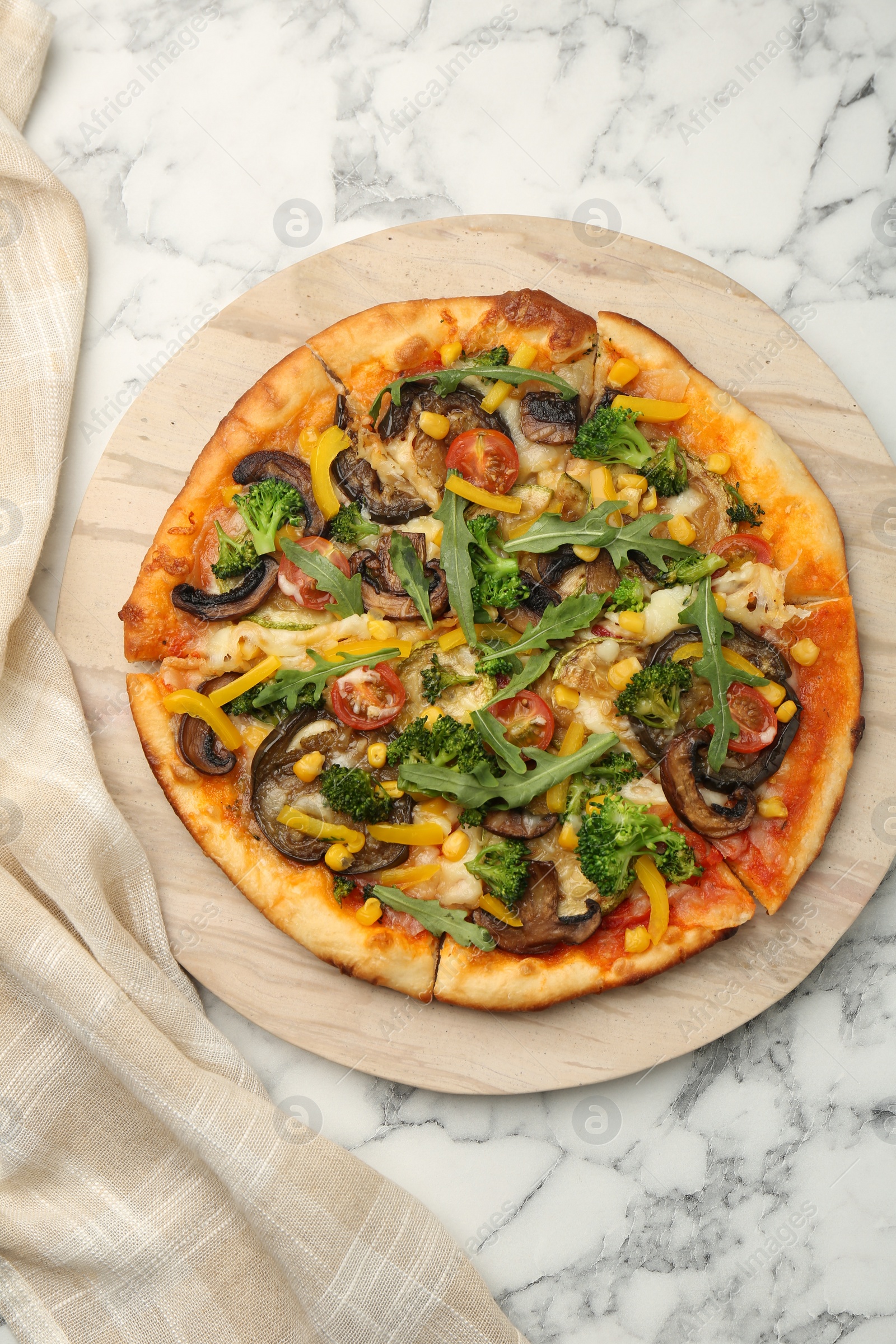 Photo of Delicious vegetarian pizza with mushrooms, vegetables and arugula on white marble table, top view