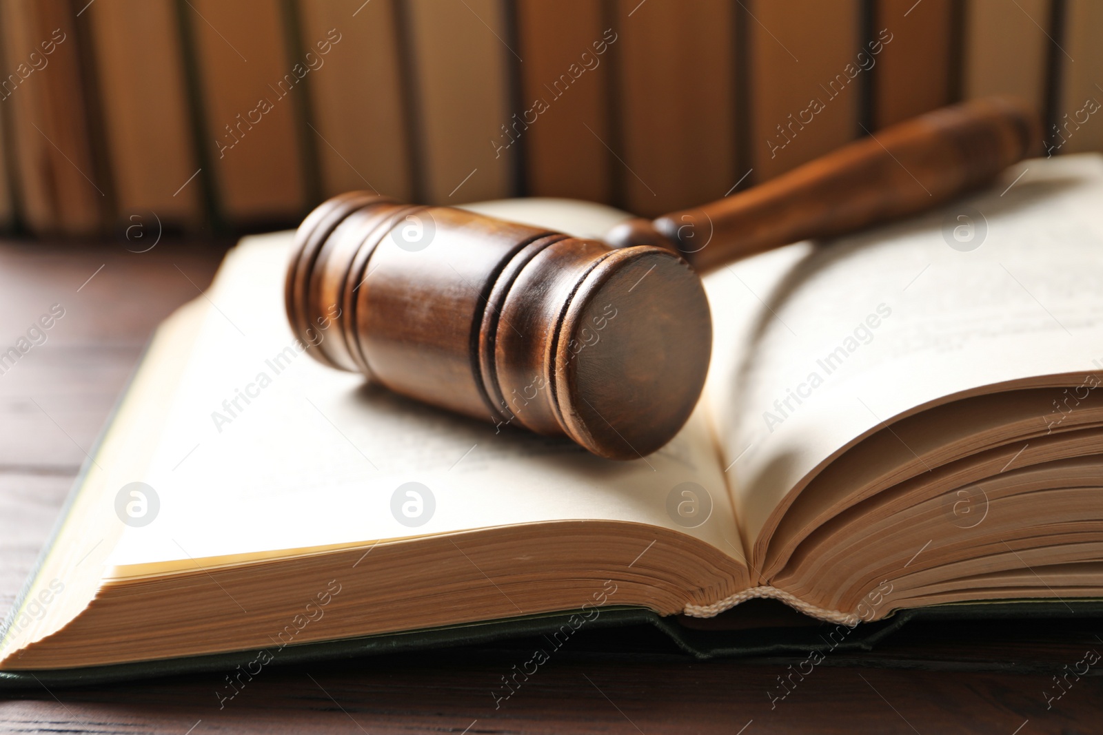 Photo of Wooden gavel and books on table, closeup. Law concept