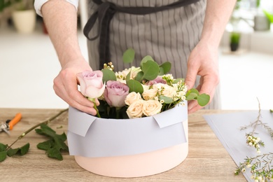 Male florist creating floral composition at workplace