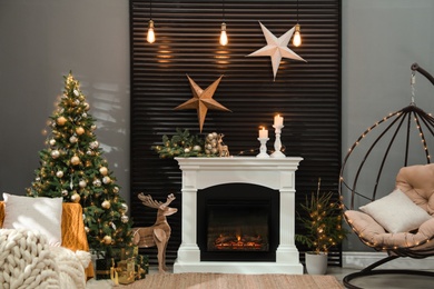 Beautiful living room interior with burning fireplace. Christmas celebration