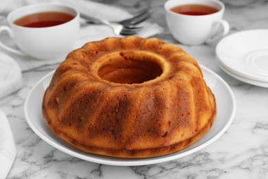 Homemade yogurt cake on white marble table