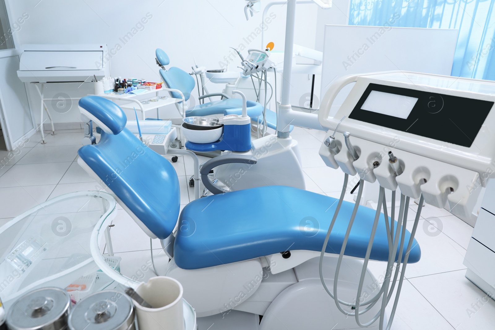 Photo of Dentist's office interior with chair and modern equipment