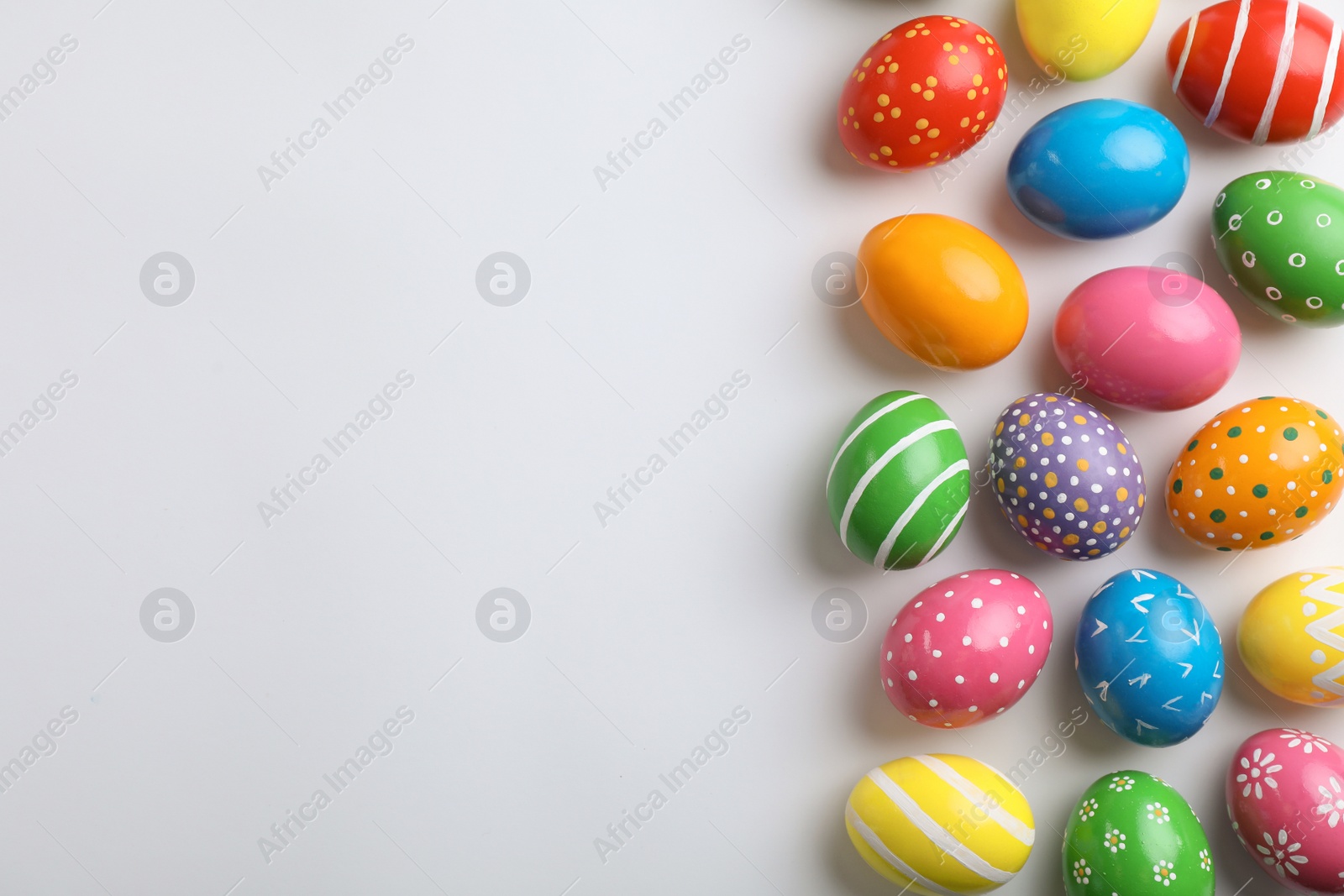 Photo of Decorated Easter eggs and space for text on white background, top view