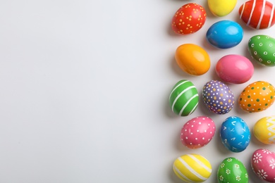 Decorated Easter eggs and space for text on white background, top view