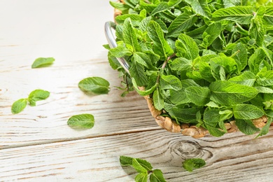 Tray with fresh mint on wooden table