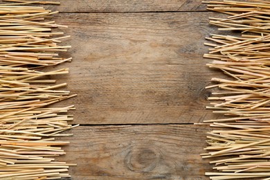 Dried hay on wooden background, flat lay. Space for text