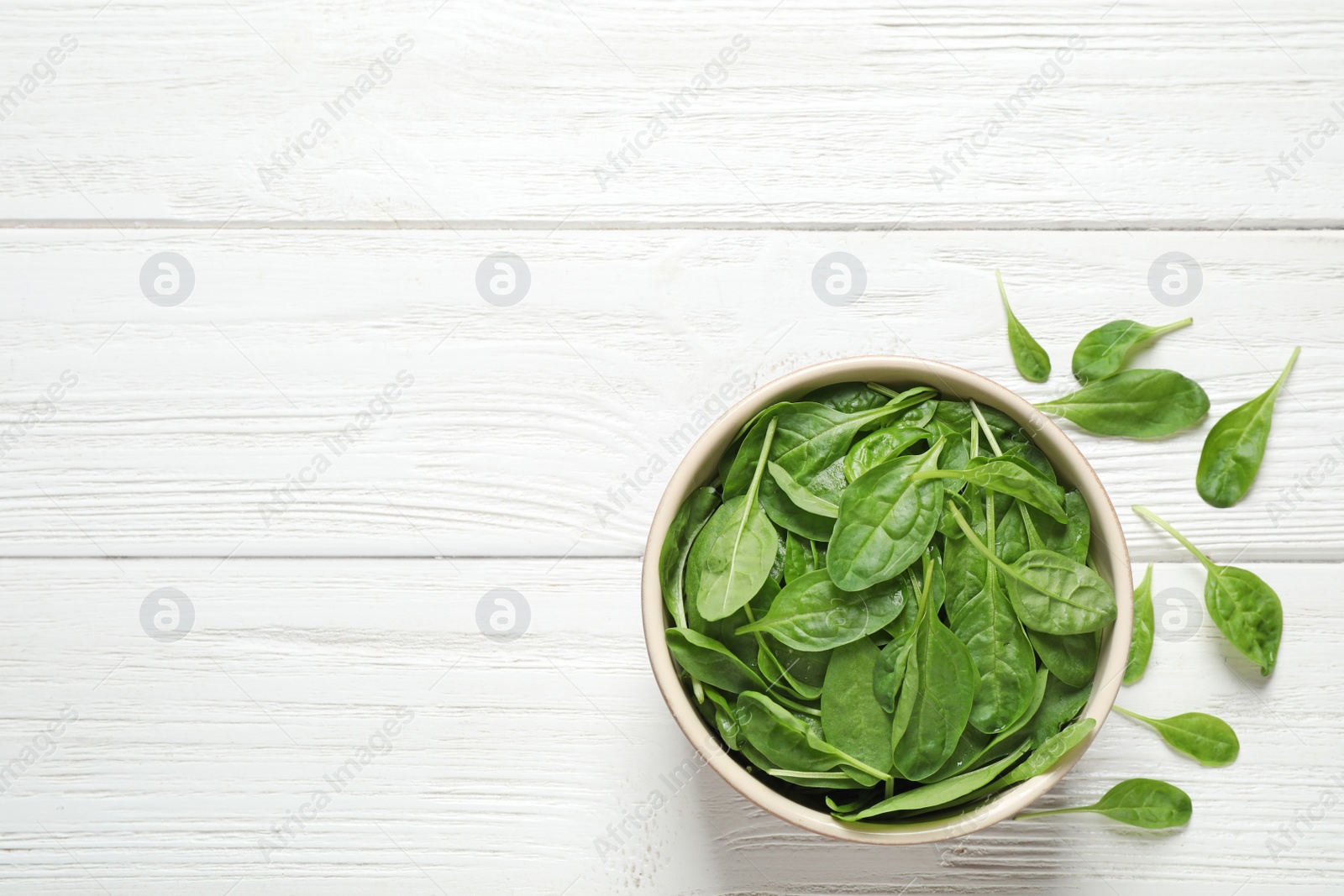 Photo of Fresh green healthy spinach on white wooden table, flat lay. Space for text