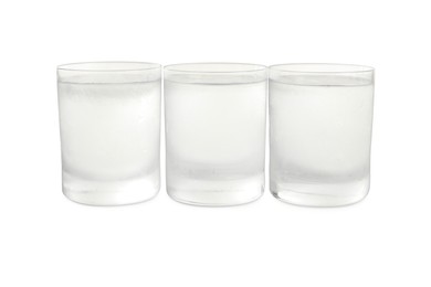 Photo of Vodka in shot glasses on white background