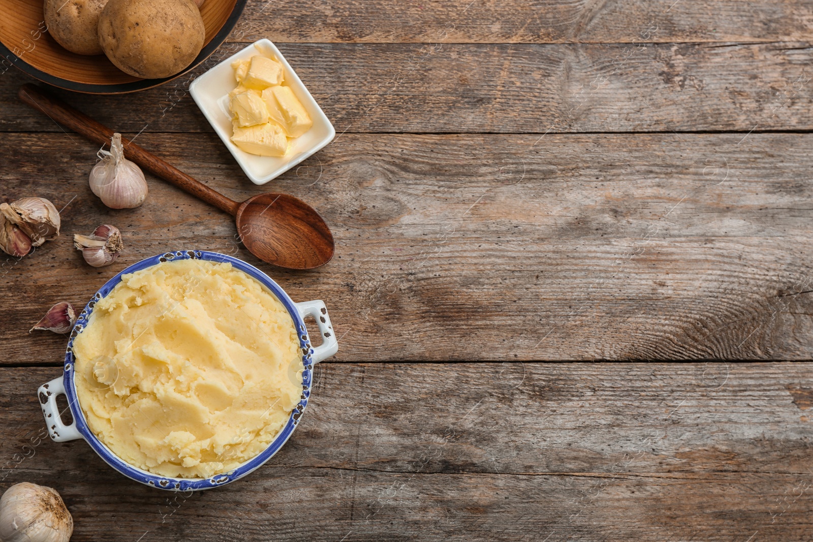 Photo of Flat lay composition with tasty mashed potato and space for text on wooden table