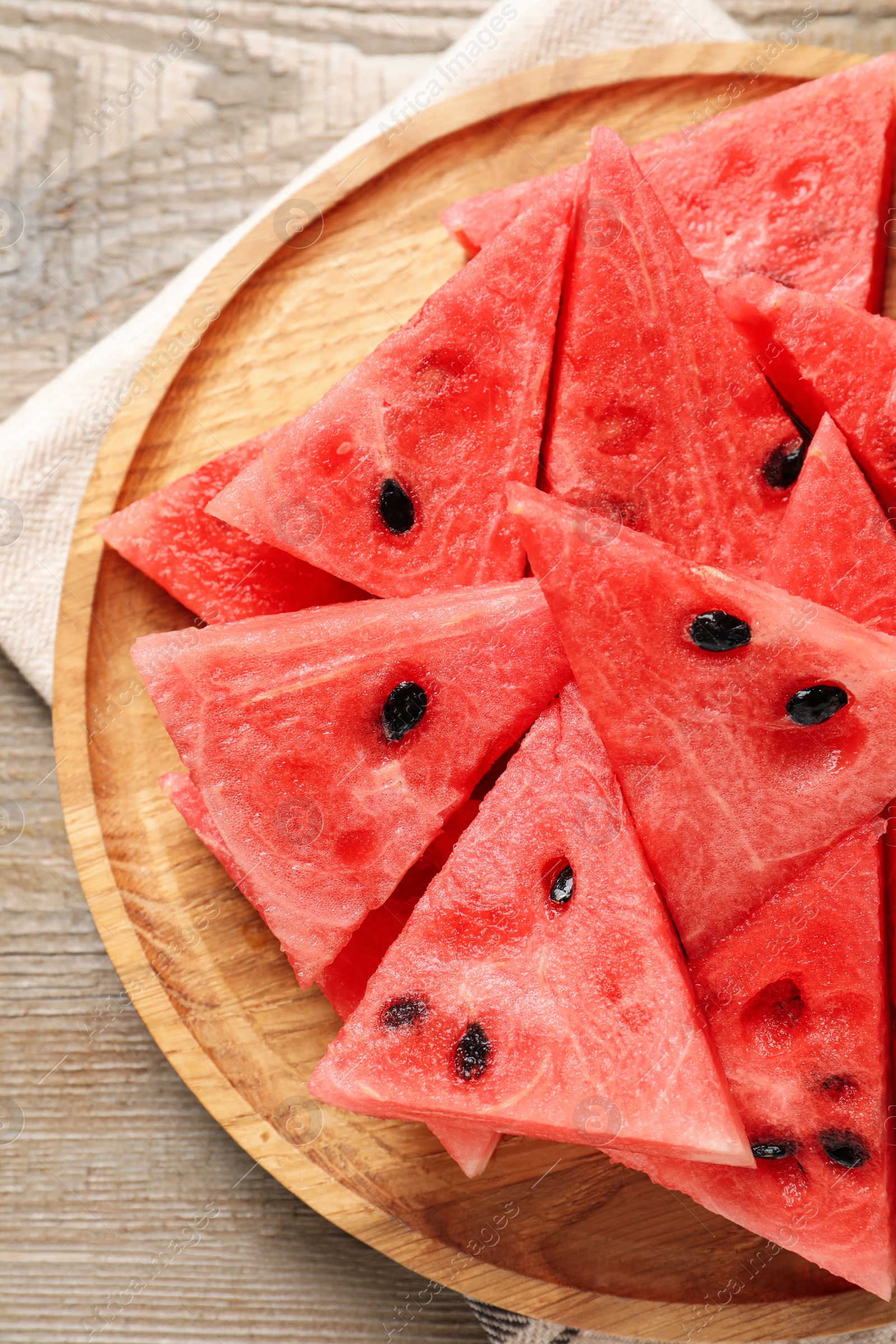 Photo of Delicious fresh watermelon slices on wooden table, top view