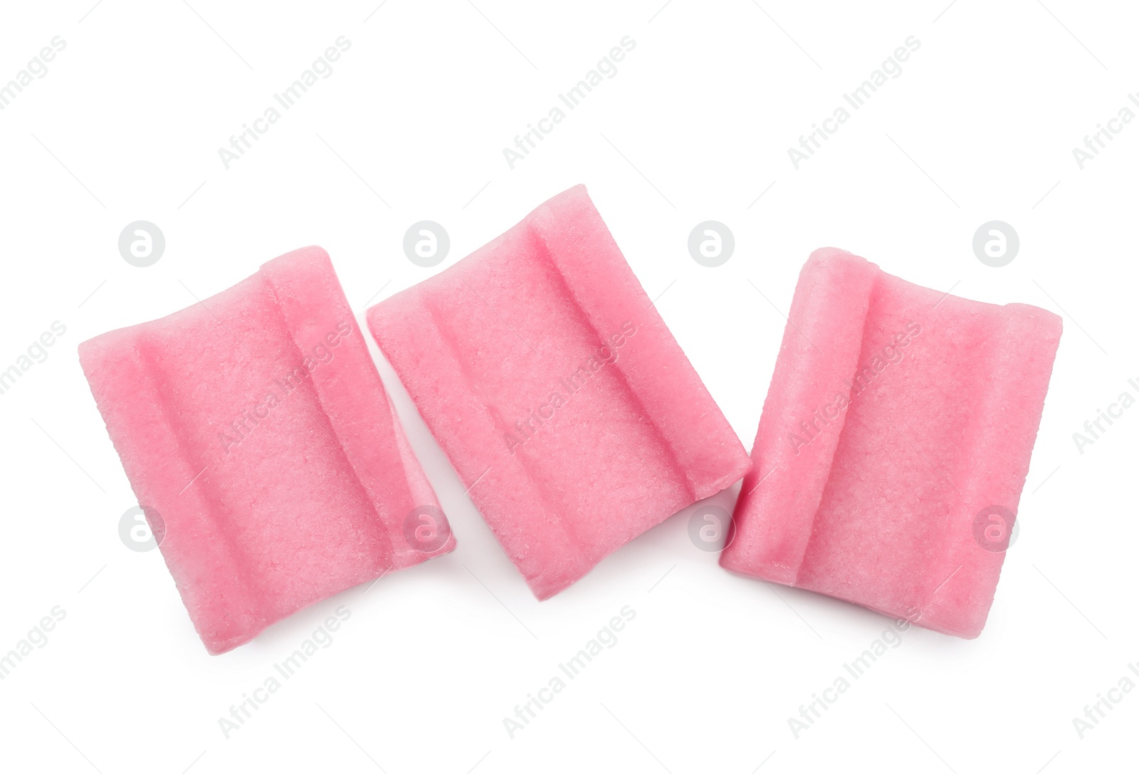 Photo of Tasty pink chewing gums on white background, top view