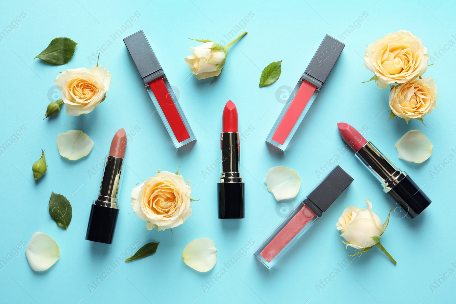 Photo of Flat lay composition with lipsticks and roses on color background