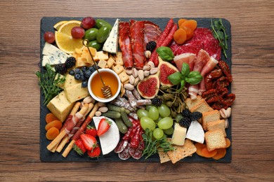 Set of different delicious appetizers served on wooden table, top view
