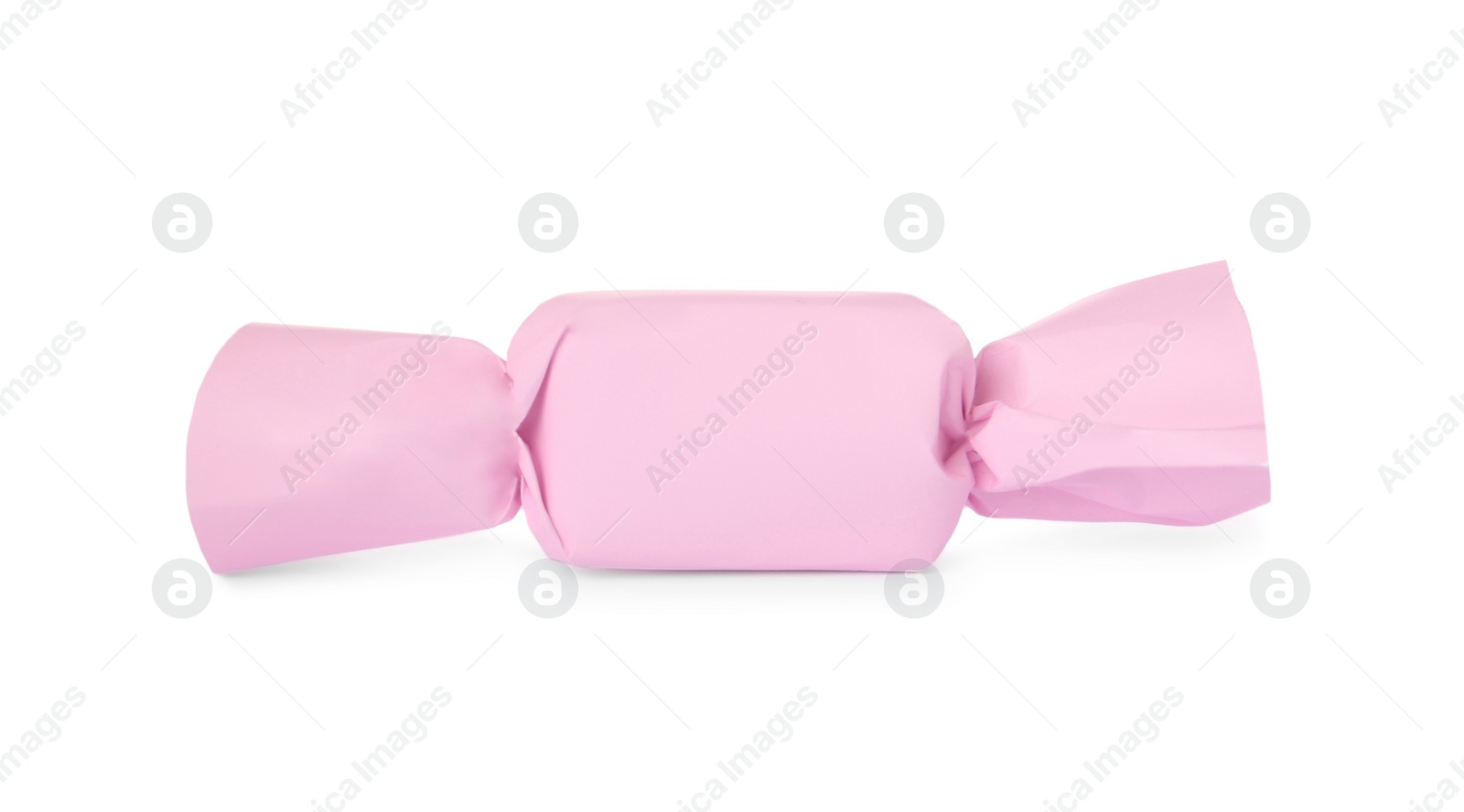 Photo of Delicious candy in light pink wrapper isolated on white