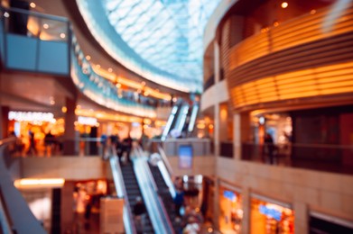 Big shopping mall with many stores, blurred view