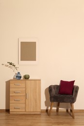 Photo of Room interior with armchair and wooden cabinet