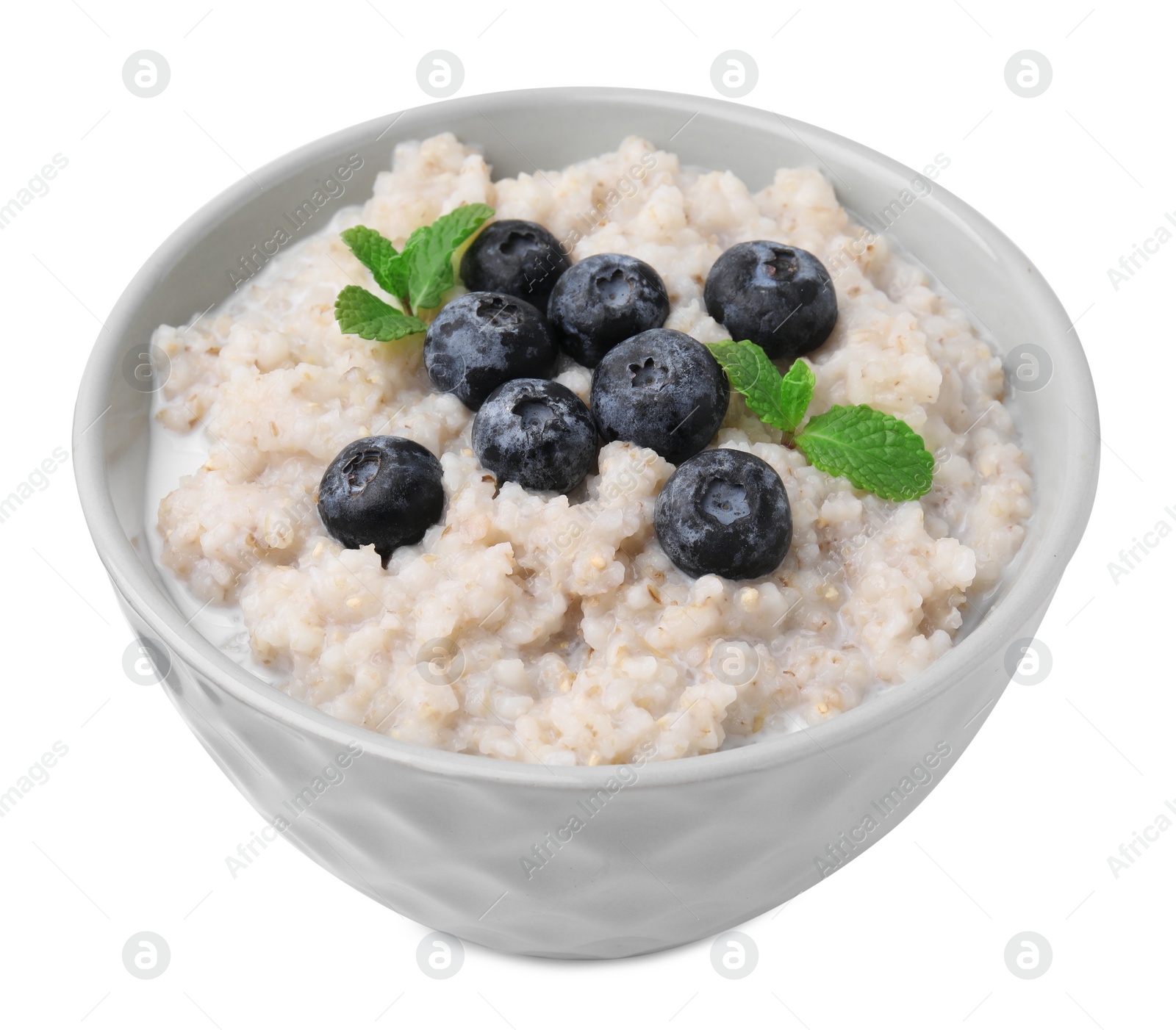 Photo of Delicious barley porridge with blueberries and mint in bowl isolated on white
