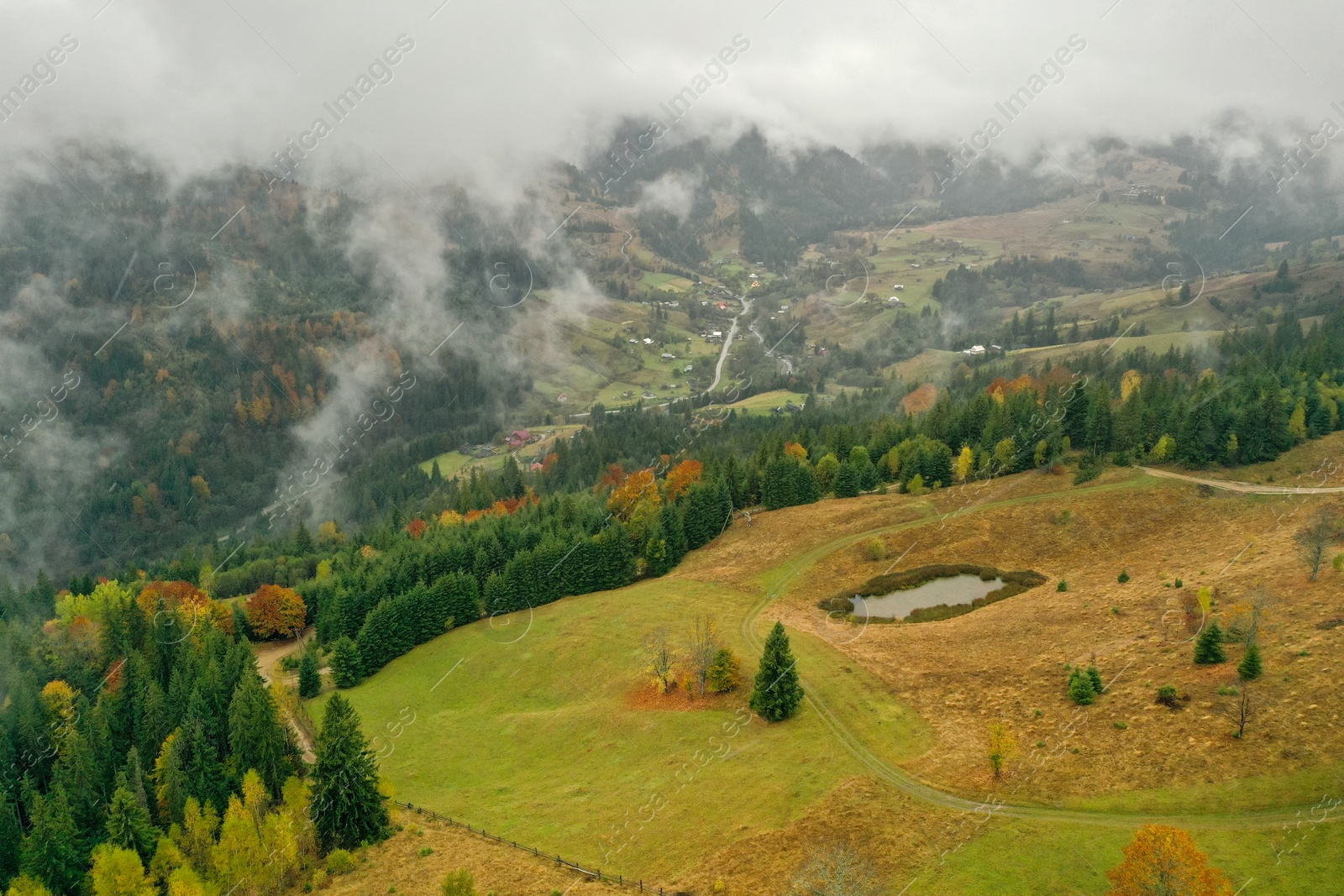 Photo of Aerial view of mountains covered with fog