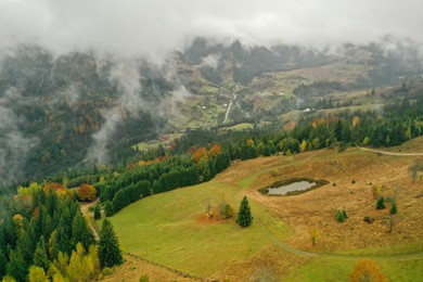 Photo of Aerial view of mountains covered with fog