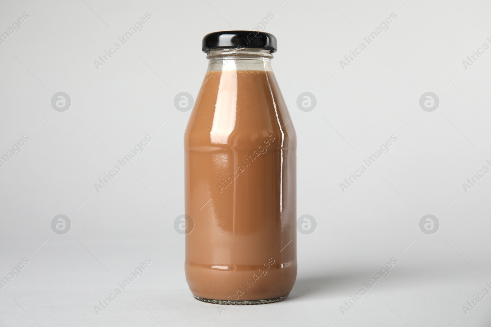 Photo of One bottle with tasty drink on color background