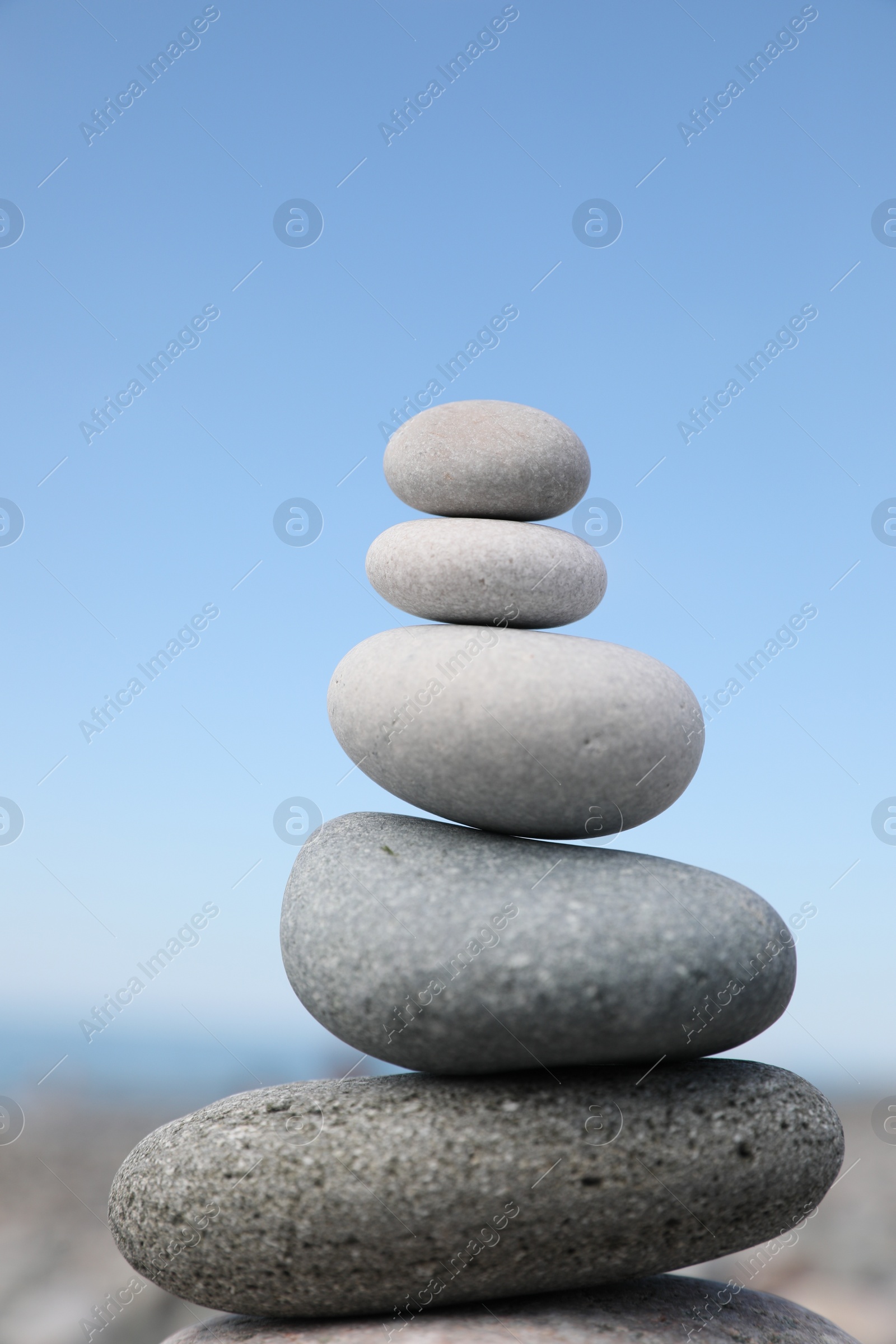 Photo of Stack of stones on beach against blurred background, closeup