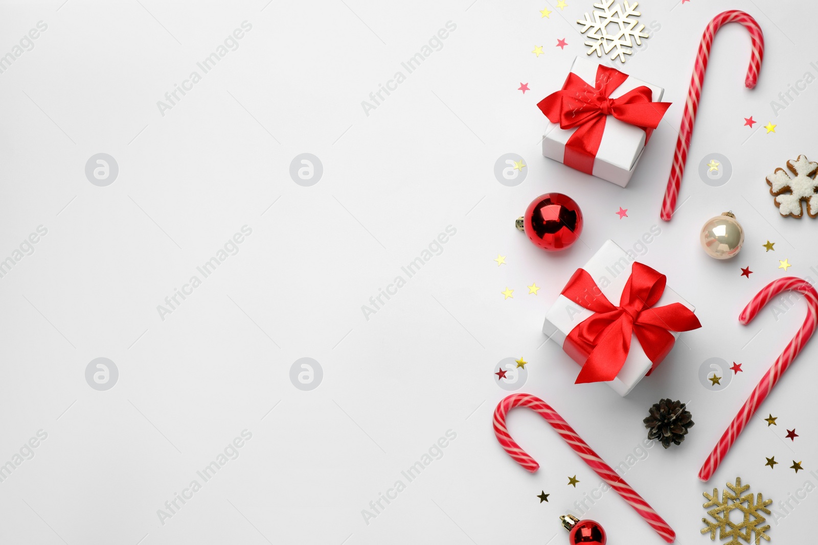 Photo of Flat lay composition with sweet candy canes and Christmas decor, space for text