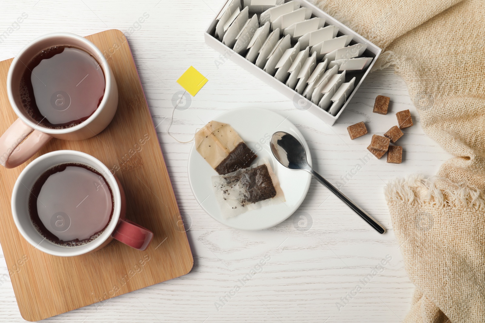 Photo of Flat lay composition with fresh tea and bags on wooden background