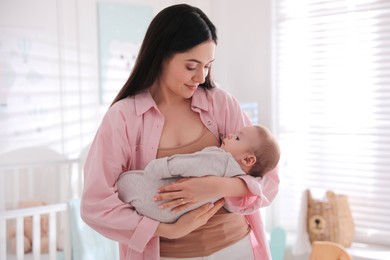 Young woman with her cute baby at home