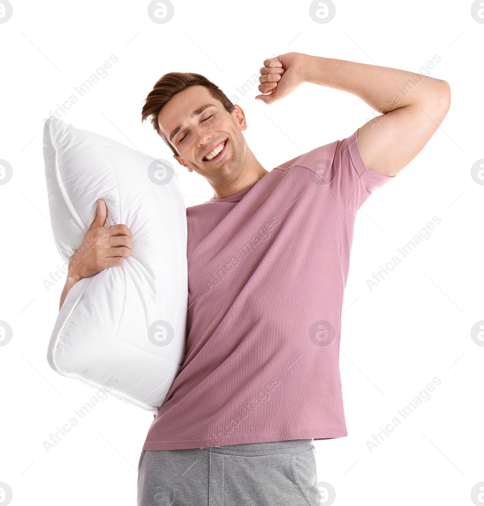 Photo of Young man in pajamas with pillow on white background