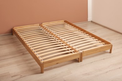 Photo of Wooden bed frame on floor in room