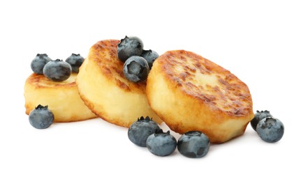 Photo of Delicious cottage cheese pancakes with fresh blueberries on white background