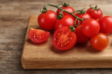 Fresh ripe cherry tomatoes on wooden table, closeup