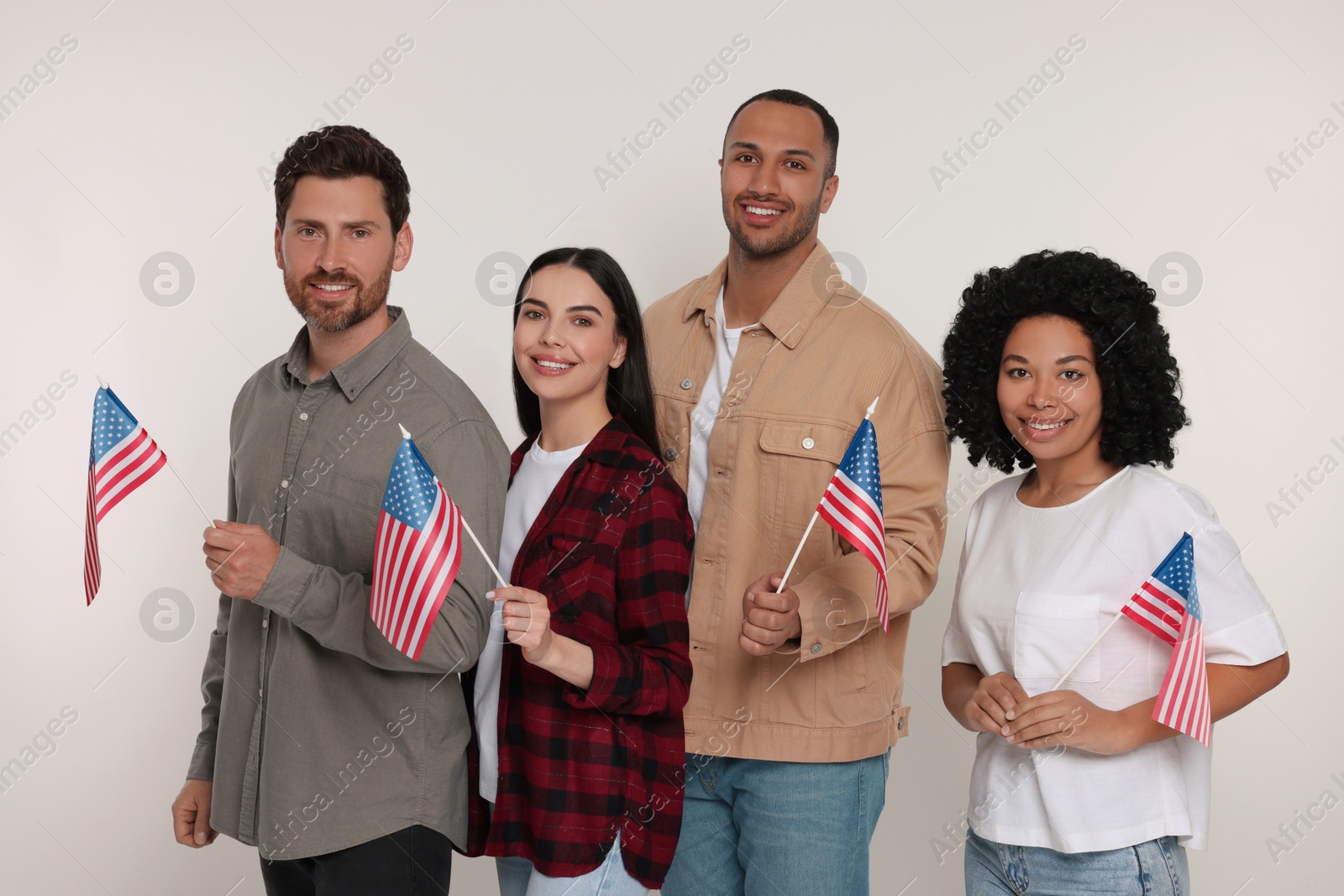 Photo of 4th of July - Independence Day of USA. Happy friends with American flags on white background