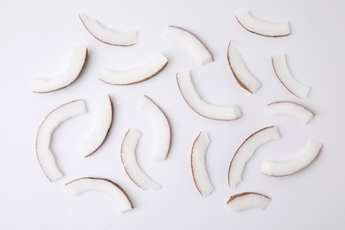 Pieces of fresh coconut on white background, top view