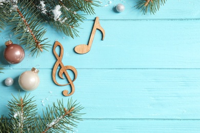 Notes on blue wooden background, flat lay with space for text. Christmas music concept