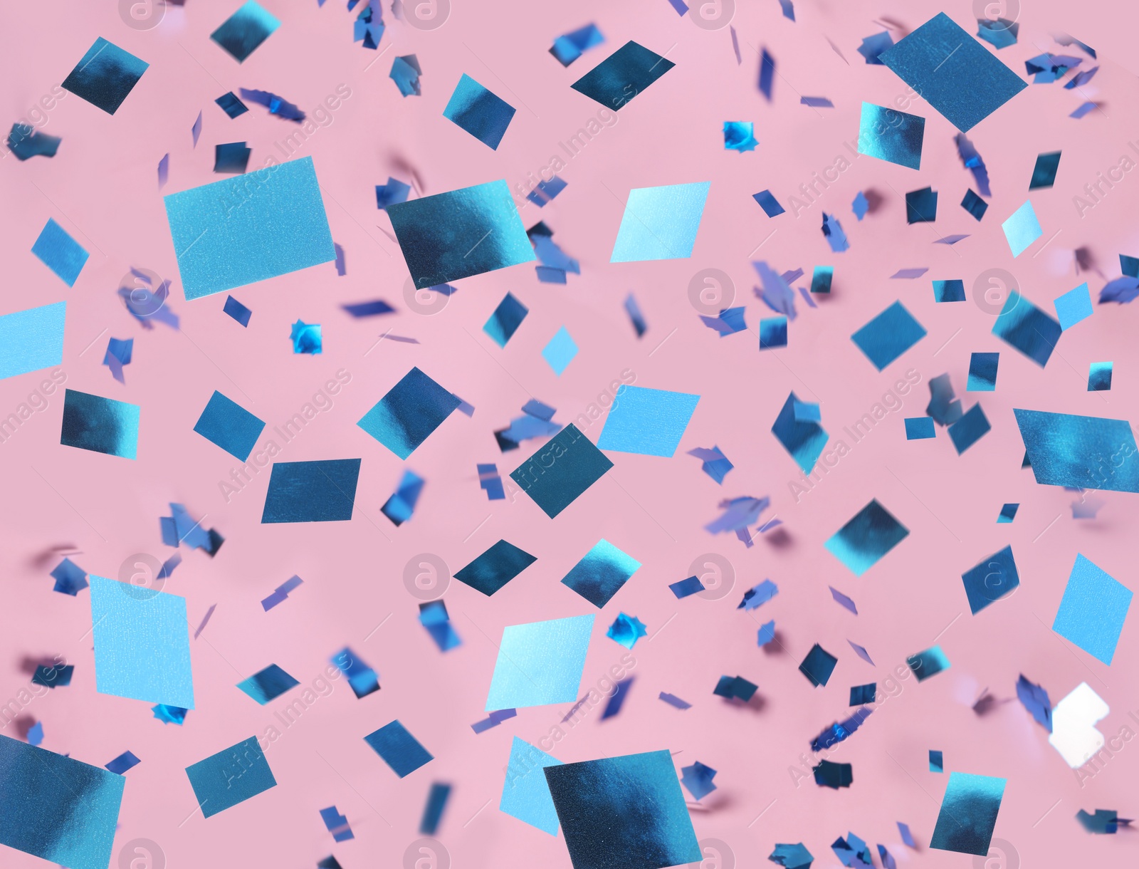 Image of Shiny blue confetti falling down on pink background