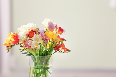 Photo of Beautiful bouquet of freesia flowers on blurred background